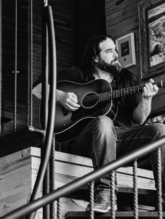 Chuck Royer playing acoustic guitar